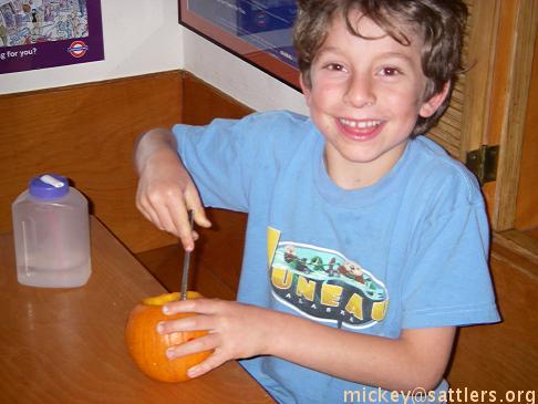 Isaac carves a pumpkin